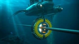 Illustration of a sophisticated cable-cutting device operating at great ocean depths.